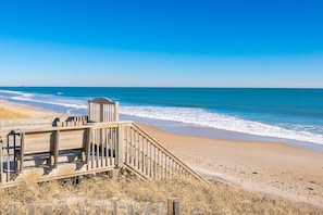 A wooden boardwalk leading to a beach with a clear view of the ocean. - Island Life - Amazing Oceanfront 9 BR Home with Pool, Theatre Room & More! (North Topsail Beach)