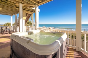 A hot tub on a wooden deck with a view of the ocean. - Island Life - Amazing Oceanfront 9 BR Home with Pool, Theatre Room & More! (North Topsail Beach)