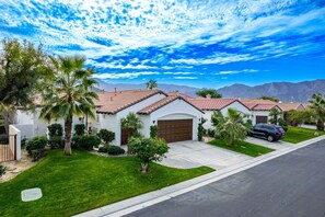 A residential area with houses featuring red-tiled roofs, well-maintained lawns, and palm trees. - Incredible Views From This 4 Bedroom Pool Home With Office and Sofa Sleeper (La Quinta)