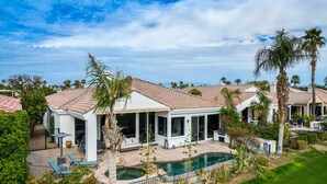 A residential property with a swimming pool, covered patio, and lush landscaping. - Incredible Views From This 4 Bedroom Pool Home With Office and Sofa Sleeper (La Quinta)