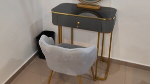A vanity with a round mirror, a small drawer, and a stool. - Padang Serai Deluxe Roomstay (Padang Serai)