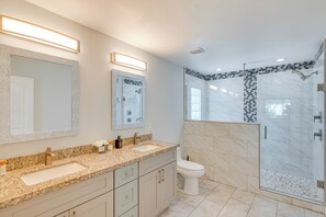 A modern bathroom with a double sink vanity, a toilet, and a walk-in shower with glass doors. - 2 Mi to Golf: Poolside Paradise in Scottsdale! (Scottsdale)