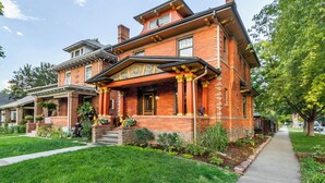 A Victorian-style brick house with a front porch, a covered entryway, and a well-maintained lawn. - 2 Mi to Downtown Denver: Stylish Gem w/ Fireplace! (Denver)