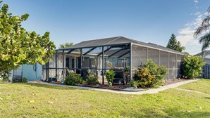 A modern greenhouse structure with a transparent roof and walls, surrounded by a well-maintained lawn and various plants. - Port Charlotte Paradise w/ Private Outdoor Oasis! (Port Charlotte)