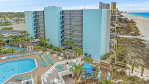 A hotel with a pool, beach view, and multiple balconies. - Moondrifter 207 - Condo with Spectacular Views (Panama City Beach)