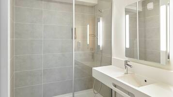 Een douche, handdoeken, zeep, shampoo