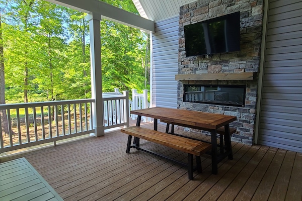 Main floor covered Deck eating area - with TV and fireplace