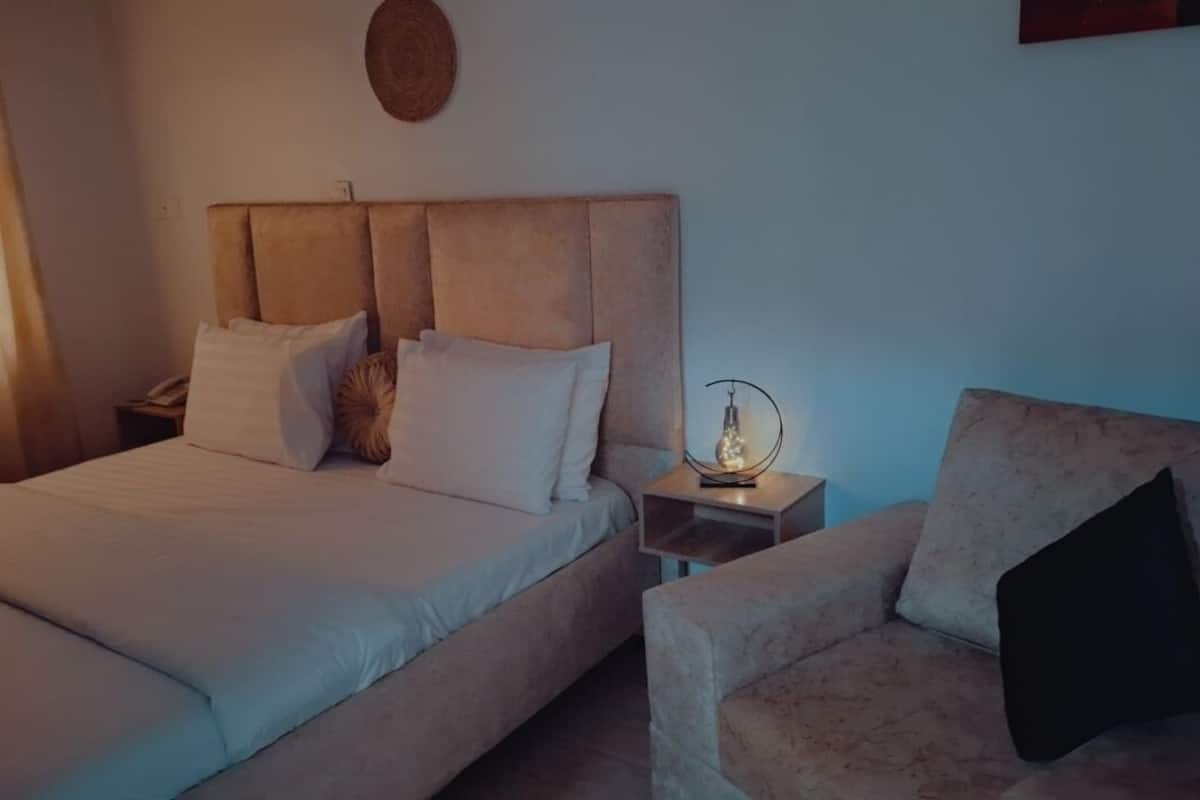A living room with a sofa, a coffee table, and a lamp.