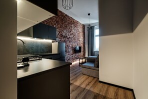 Business Studio Suite | Living area | 37-inch flat-screen TV with digital channels - RentPlanet - Apartamenty Krasińskiego (Wroclaw)