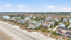 A coastal residential area with houses featuring balconies and beach access. - Arrogantly Shabby - Oceanfront (Pawleys Island)