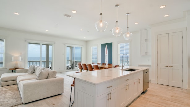 A spacious kitchen with a large island, white cabinetry, and pendant lighting. - Beach House - Whale Rested by PHG (Panama City Beach)
