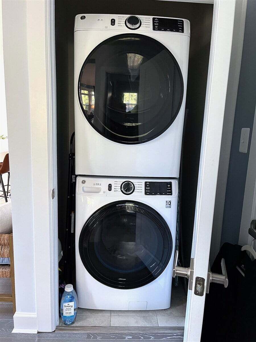 Una sala de lavandería con dos lavadoras apiladas.