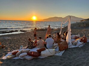 Guests can relax on the beach with ocean views.
