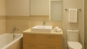 A modern bathroom with a bathtub, sink, vanity, and toilet. - Villa - Sleeps 10 - Pool - Garden - Parking (Hersonissos)