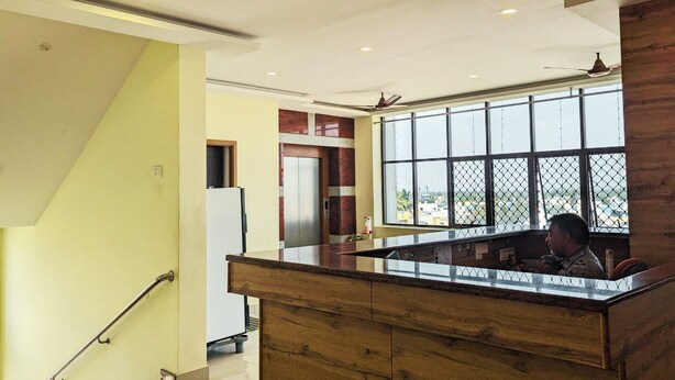 Una cocina con mostrador de madera, un refrigerador y una ventana con vistas al exterior.