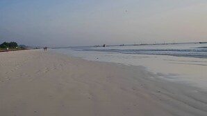 A wide sandy beach with gentle waves and a clear blue sky. - Al Mahali Villas (Diani Beach)