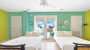 A room with two single beds, a ceiling fan, and a view of the outside.