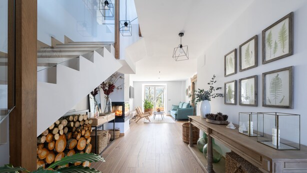 A modern interior with a staircase, wooden flooring, a dining area, and framed botanical prints on the walls. - Soloandie (Zeanuri)