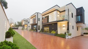 A modern residential complex with multiple two-story houses, a paved driveway, and well-maintained landscaping. - Kumasi Luxury Apartments at The Fairview (Kumasi)