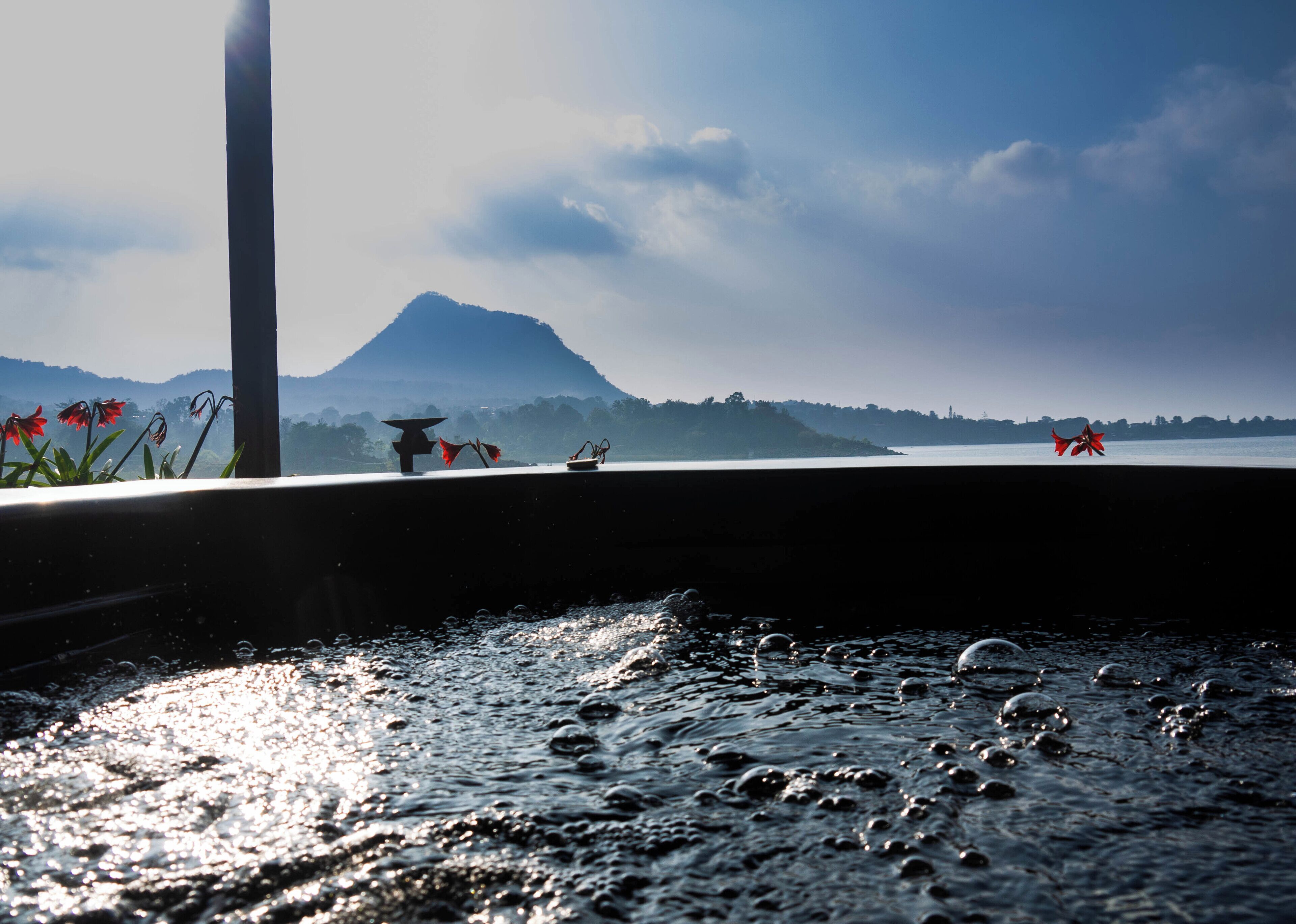 A water feature with a mountain in the background.