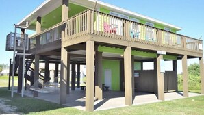 A two-story building with a balcony, a staircase, and a hammock. - 50 yards to sand and views, the best value for proximity! (Bolivar Peninsula)