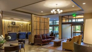 A lobby with a reception desk, seating area, and a large window providing a view of the outdoors. - Presidential Unit at a World Class Ski Resort
 (Avon)