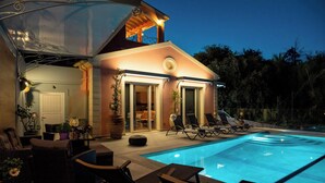 A pool area with lounge chairs and a covered seating area. - Villa Jewel in Corfu (Kontokali)