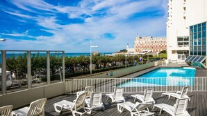 A rooftop pool area with lounge chairs, a view of the ocean, and a building in the background. - Furnished Studio 2** - On the edge of the Grande Plage - Swimming pool - Terrace (Biarritz)