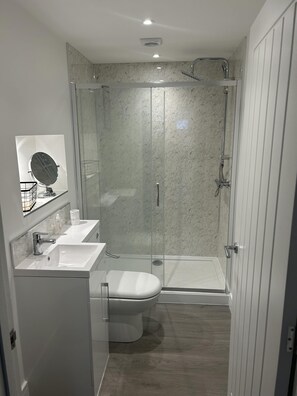 Appartement | Badkamer | Een douche, een haardroger, handdoeken