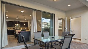A modern kitchen with dark cabinets and a stainless steel microwave. - Free Waterpark Access! 5br Resort Townhome w/ Pool (Kissimmee)