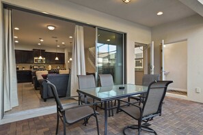 A modern kitchen with dark cabinets and a stainless steel microwave. - Free Waterpark Access! 5br Resort Townhome w/ Pool (Kissimmee)