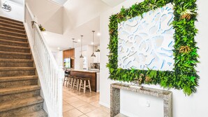 A staircase leading to a living area with a kitchen in the background. - 7BR Lake View Villa Pool Spa - Solterra Resort (Davenport)