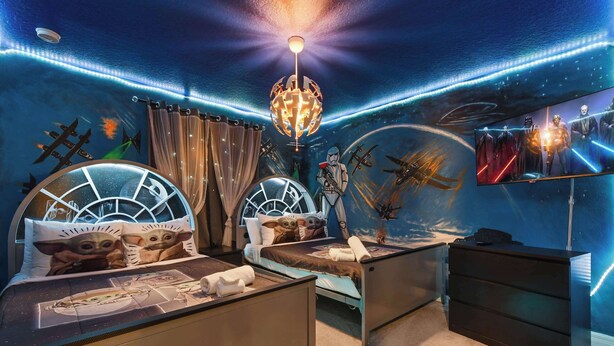 A room with two beds, a ceiling light, and a wall mural. - 7BR Solterra Resort - Newly Renovated Home w Pool (Davenport)