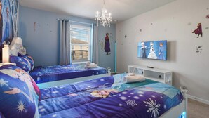 A bedroom with two beds, a TV, and a chandelier. - 7BR Solterra Resort - Newly Renovated Home w Pool (Davenport)
