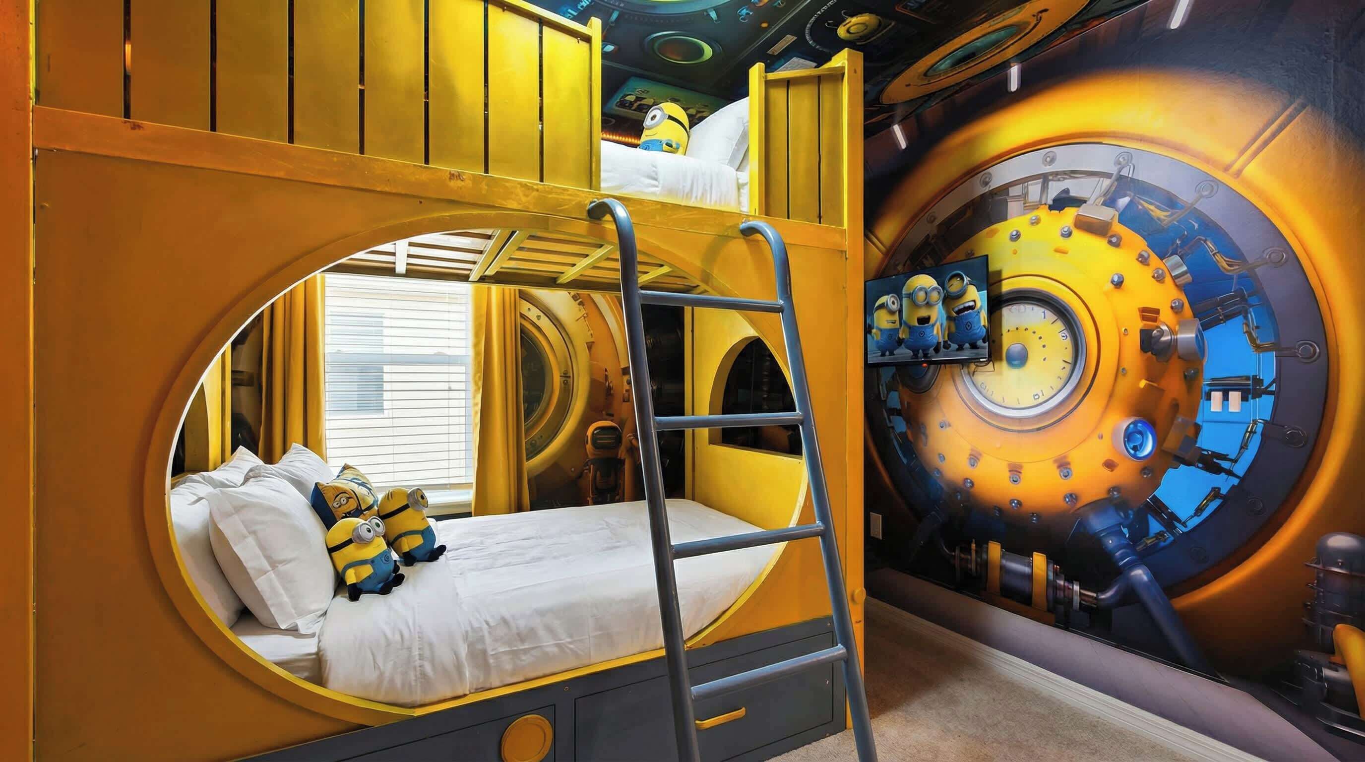 A bunk bed with a ladder, a circular window, and a Minion-themed wall.