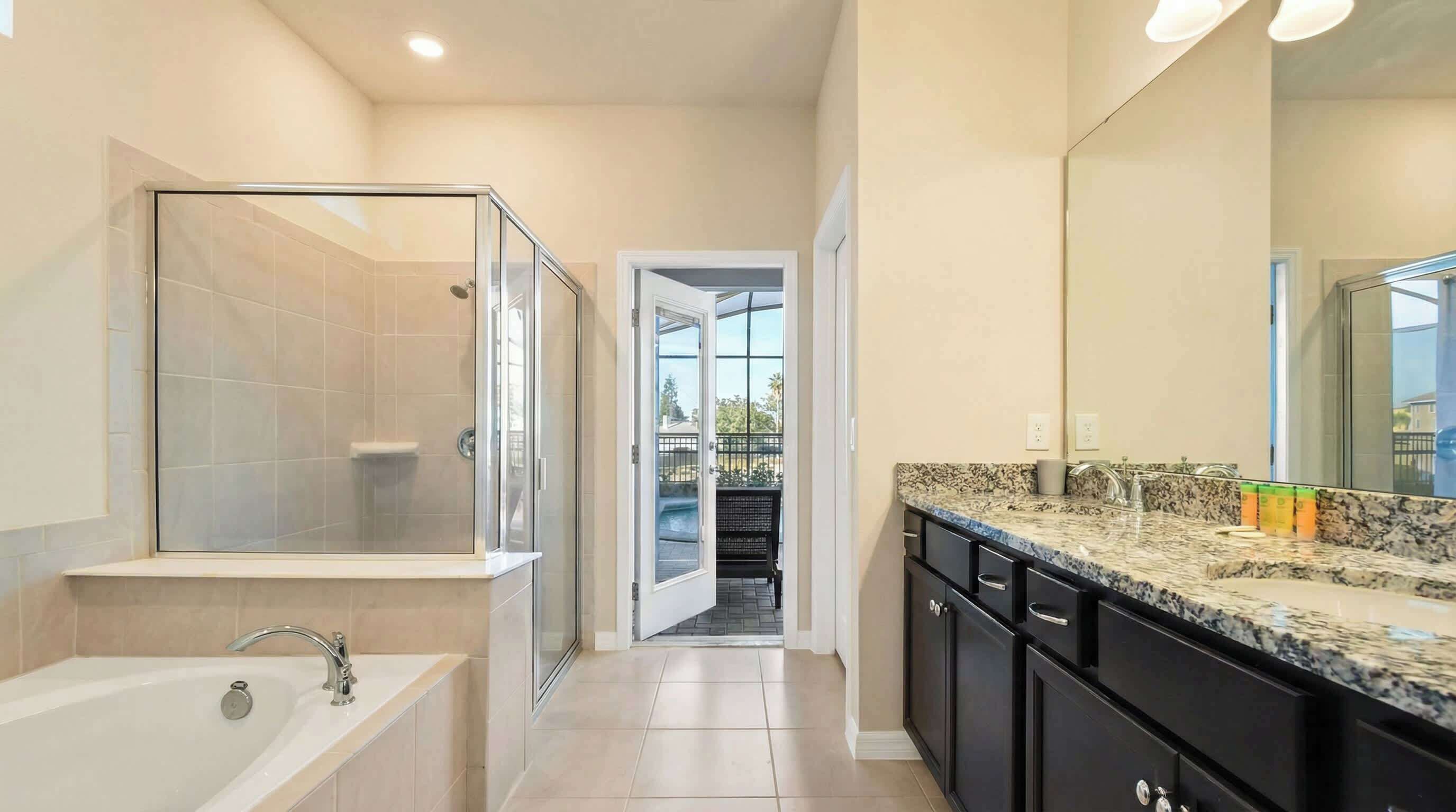 A modern bathroom with a glass-enclosed shower, a bathtub, and a vanity with a large mirror.