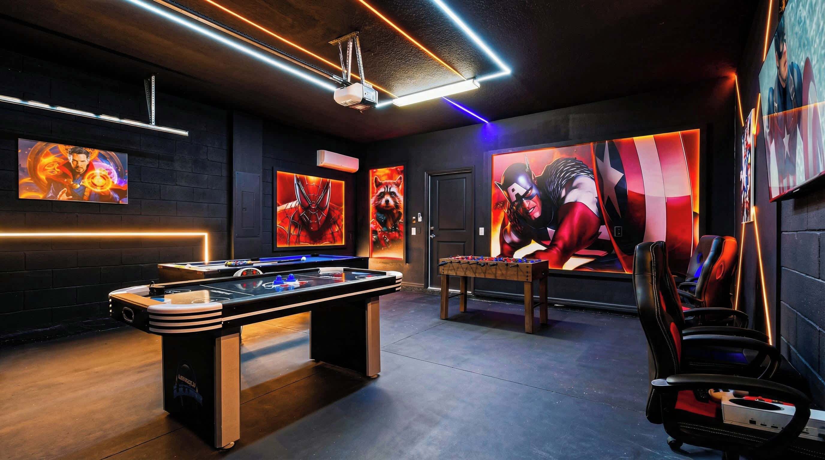 A room with a foosball table, a pool table, and a projector screen.
