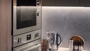 A modern kitchen with stainless steel appliances, including an oven, microwave, and toaster. - Luxurious 2bed Apartment in Greenford Quays (Greenford)