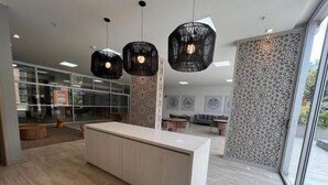A modern kitchen with a central island, pendant lights, and a view of the outdoors. - NEW LISTING! Mandala: Serenity, Luxury, and Nature! In Envigado. (Cali)