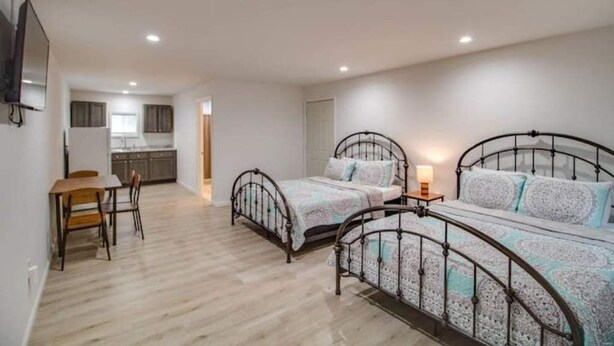 A bedroom with two beds, a desk, and a chair. - Rafton Inn Vacation Cottage 19 (Grafton)
