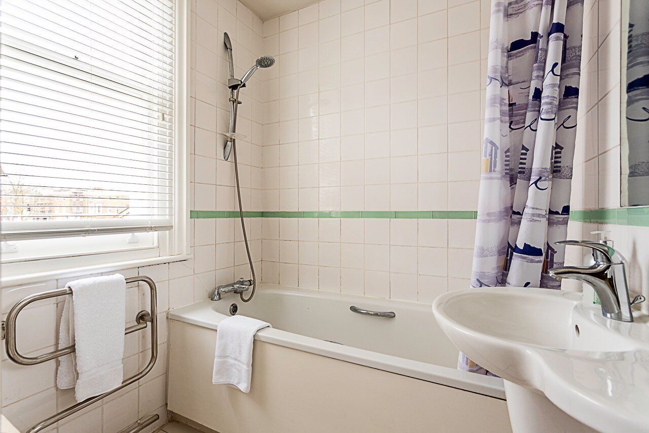 A bathroom with a bathtub, a sink, and a shower.