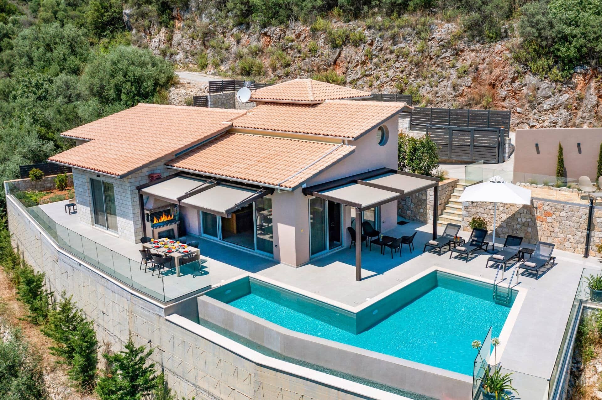 A modern villa with a swimming pool, outdoor seating, and a barbecue area.