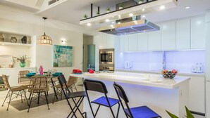 A modern kitchen with white cabinetry, a built-in microwave, and a stainless steel oven. - Villa Del Mar by Villa Plus (Caleta de Fustes)