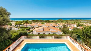 A pool area with a view of a coastal village and the sea. - Villa Caterina by Villa Plus (Alayor)