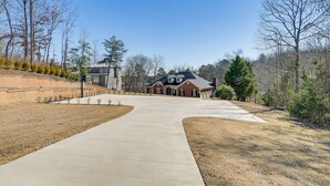 A residential driveway leading to a house with a brick exterior and a large front yard. - Lake Hartwell Getaway w/ Private Dock + Fire Pit! (Fair Play)