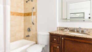 A bathroom with a bathtub, toilet, and vanity with a sink. - Marriott's SurfWatch (Hilton Head Island)