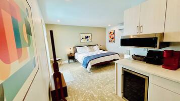 A bedroom with a bed, nightstand, and a TV.