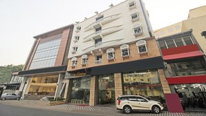 A multi-story hotel with a modern facade, featuring balconies and large windows. - SYN Elite Residency (Hyderabad)