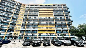 A multi-story residential building with a parking lot in front. - Emmatty Home (Lagos)