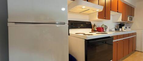 Fridge, microwave, coffee/tea maker, cookware/dishes/utensils